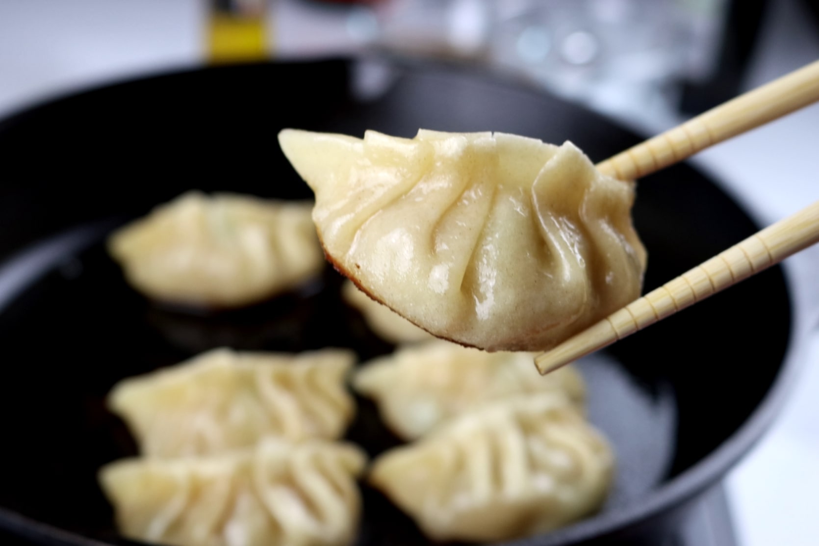 gyoza pan-fried dumplings stuffed with minced pork and cabbage. They have a golden brown crunchy base and a juicy filling