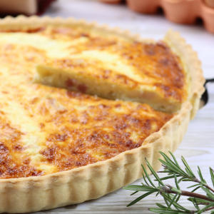 Quiche lorraine French quiche made of eggs, cream, milk, bacon and onion with a crusty shortcrust pastry