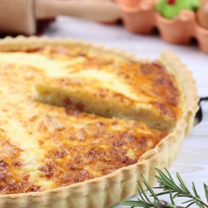Quiche lorraine French quiche made of eggs, cream, milk, bacon and onion with a crusty shortcrust pastry.