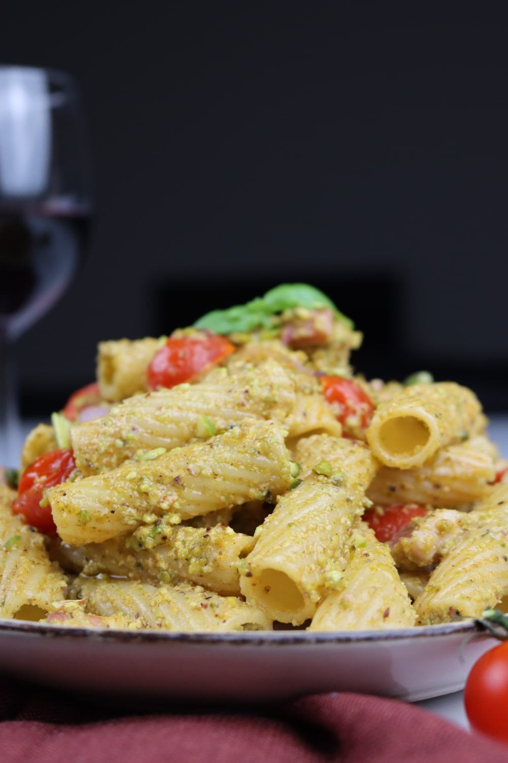 Tortiglioni with Pesto Pasta. Pesto made of fresh basil, pistachio, parmesan, accompanied by cherry tomatoes and pancetta