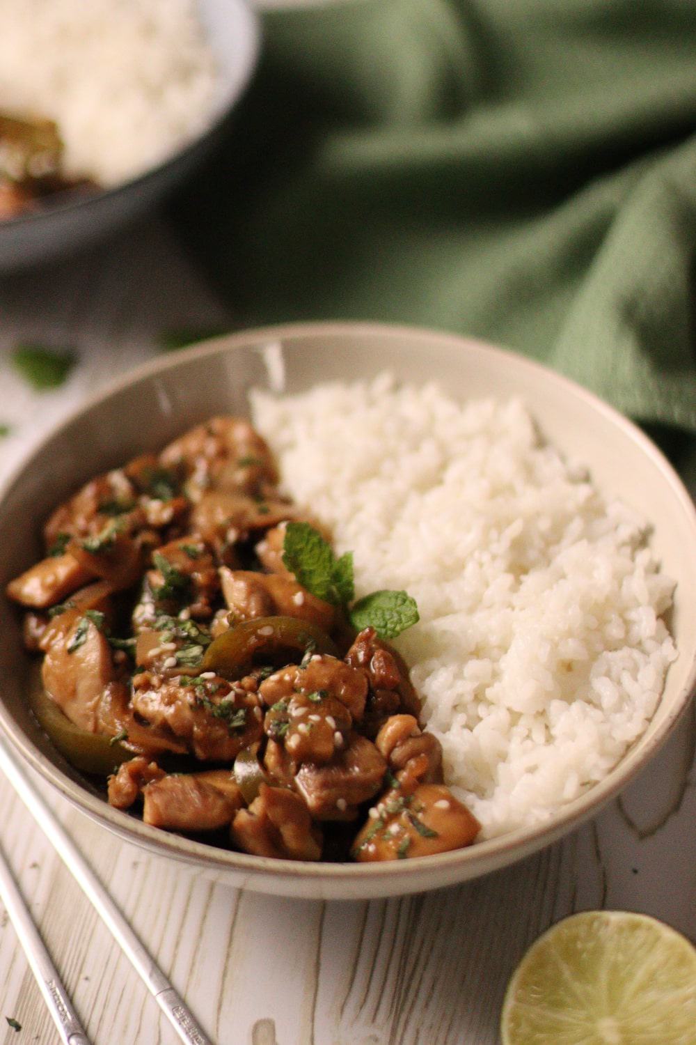 Asian style chicken marinated in a lime and hoisin marinade, cooked with mushrooms, green capsicums, onions and served with rice, mint and sesame seeds