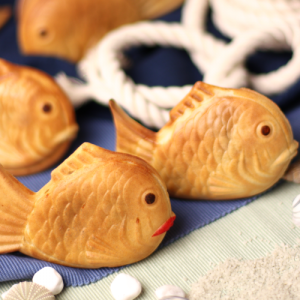 Korean street food fish-shaped pastry filled with sweet red bean and green tea matcha pudding.