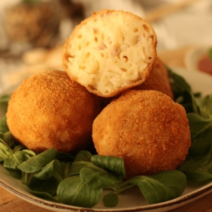 macaroni croquettes balls with ham and cheese mixed with pasta rolled into a ball then fried