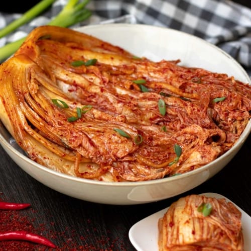kimchi with napa cabbage korean traditional side dish fermented cabbage in a spicy sauce with red chilli flakes.