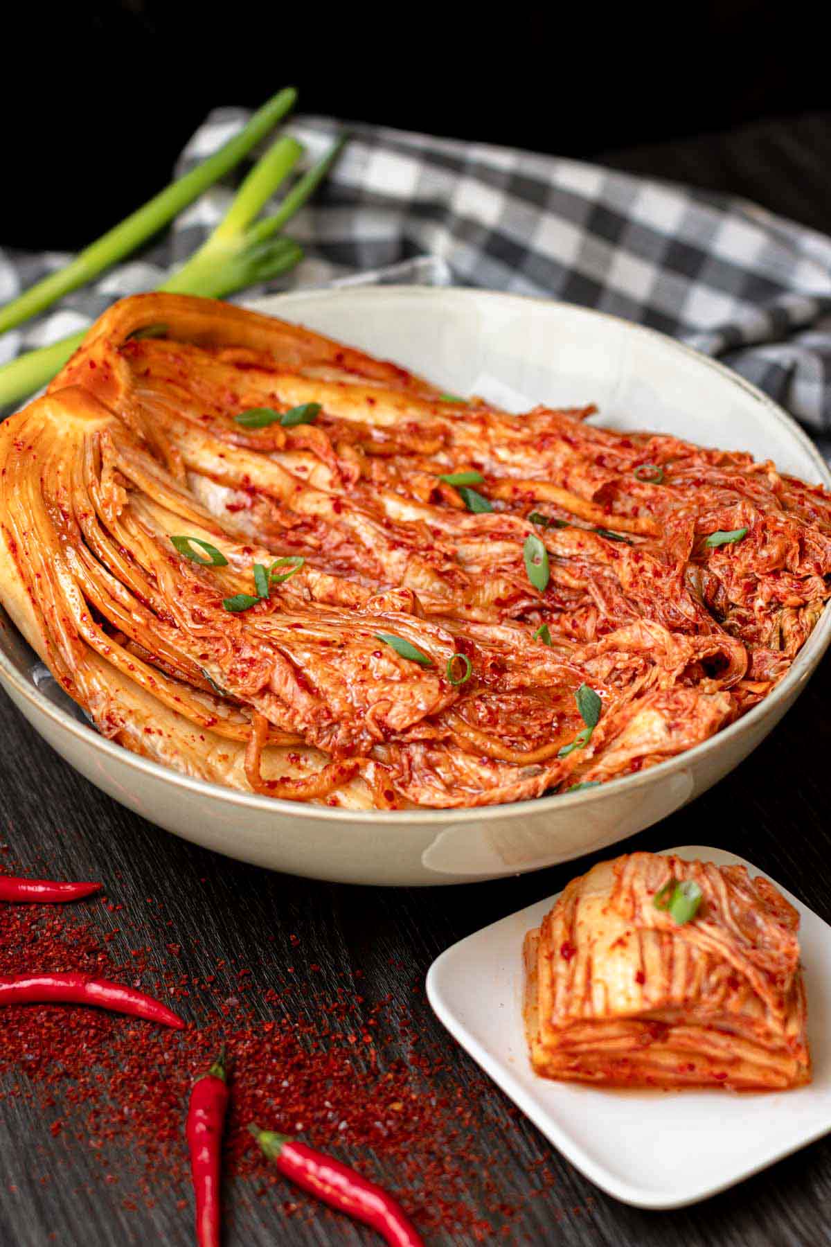 Homemade napa cabbage kimchi in a large bowl, with a smaller serving on the side.
