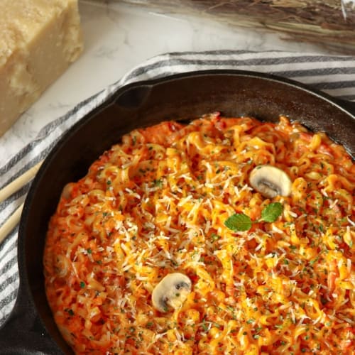 buldak Korean noodles ramen in a creamy carbonara spicy sauce with mushrooms, bacon and cream.