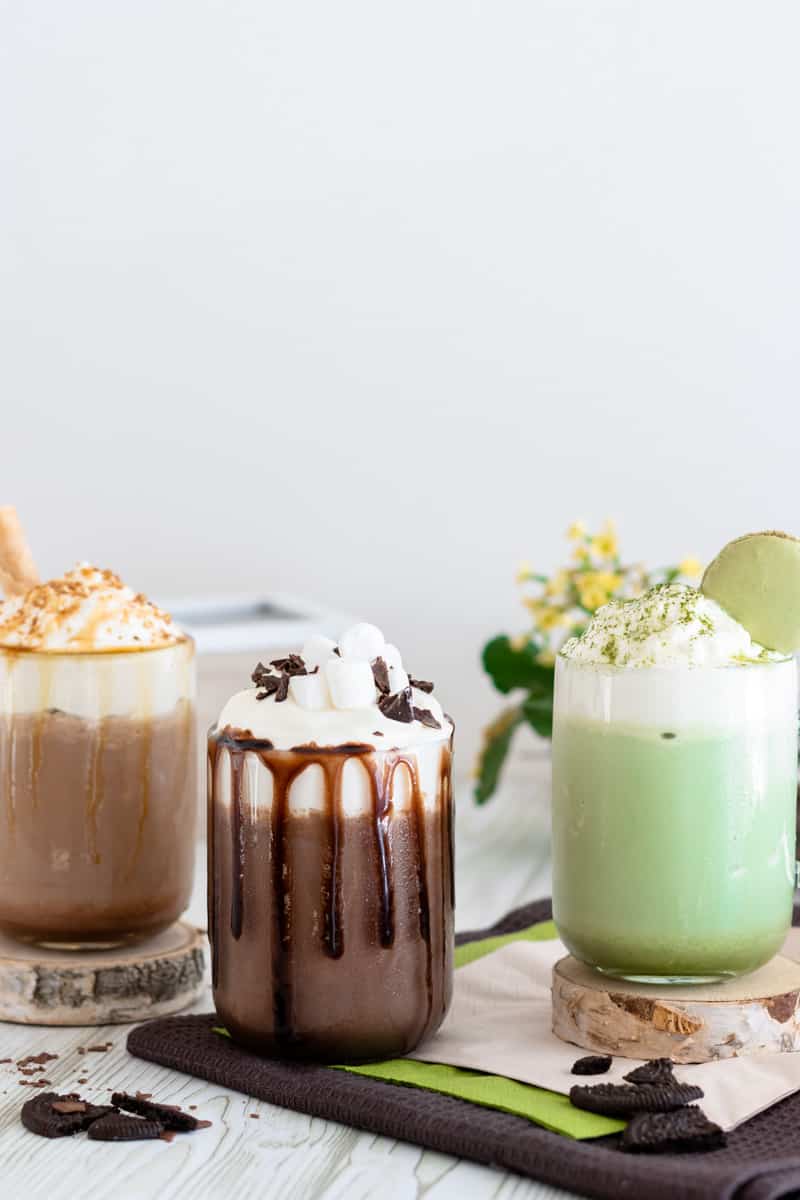 frozen hot chocolate made with crushed ice matcha, caramel and chocolate sauce topped with whipped cream