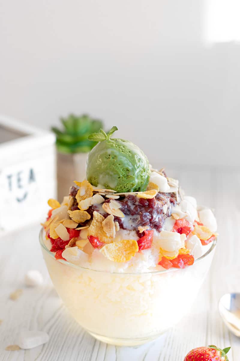 Patbingsu milky shaved ice topped up by sweet red beans, corn flakes, chewy mini rice cakes, roasted shaved almonds, strawberries, a drizzle of condensed milk and some incredible creamy homemade matcha ice cream