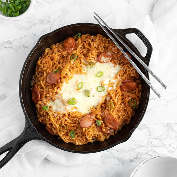 cheese buldak ramen with wurstel sausage and melted mozzarella