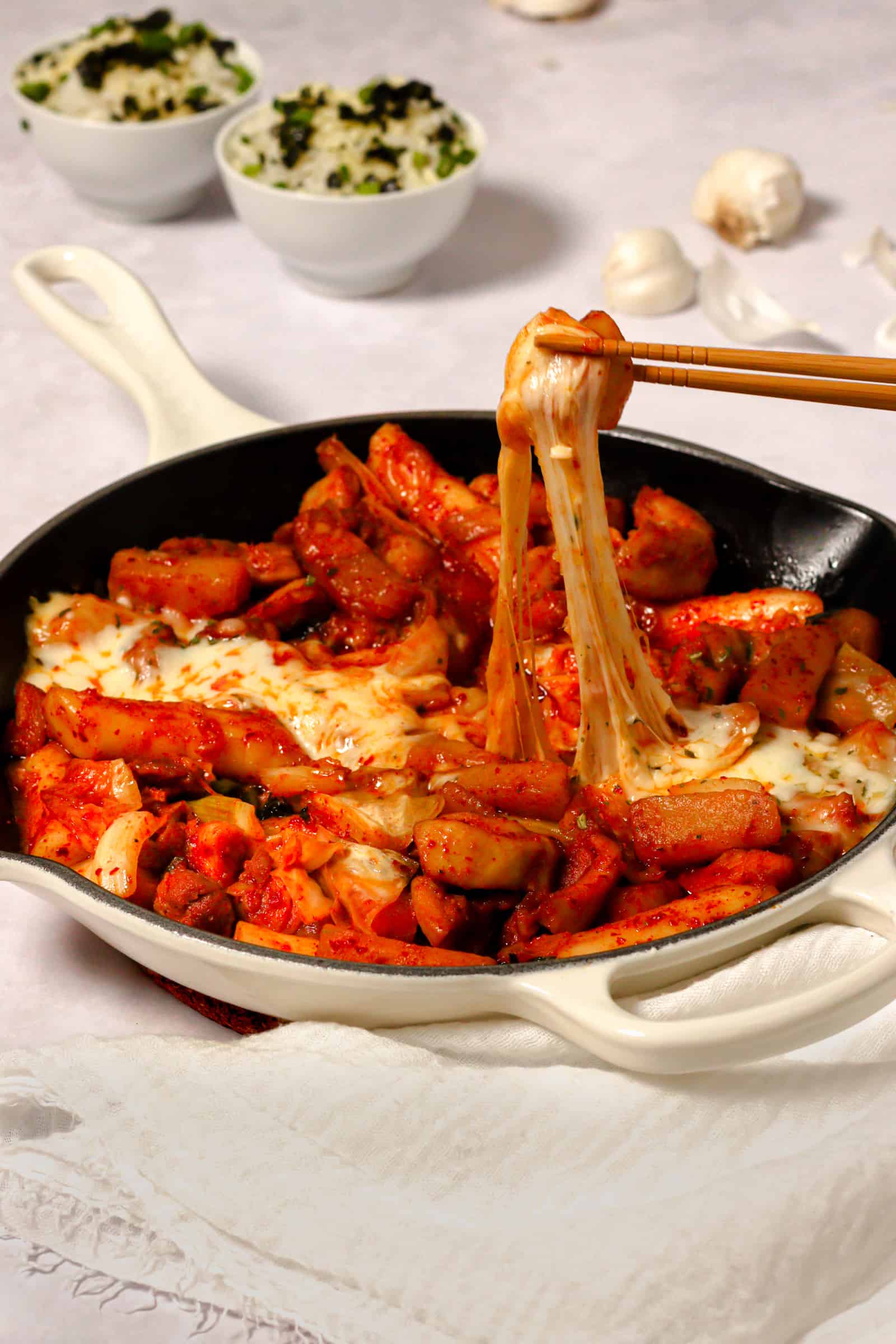 dakgalbi korean spicy chicken stir fry with Korean sweet potatoes, green cabbage, rice cakes and kkaennip