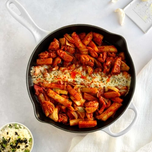 dakgalbi korean spicy chicken stir fry with Korean sweet potatoes, green cabbage, rice cakes and kkaennip