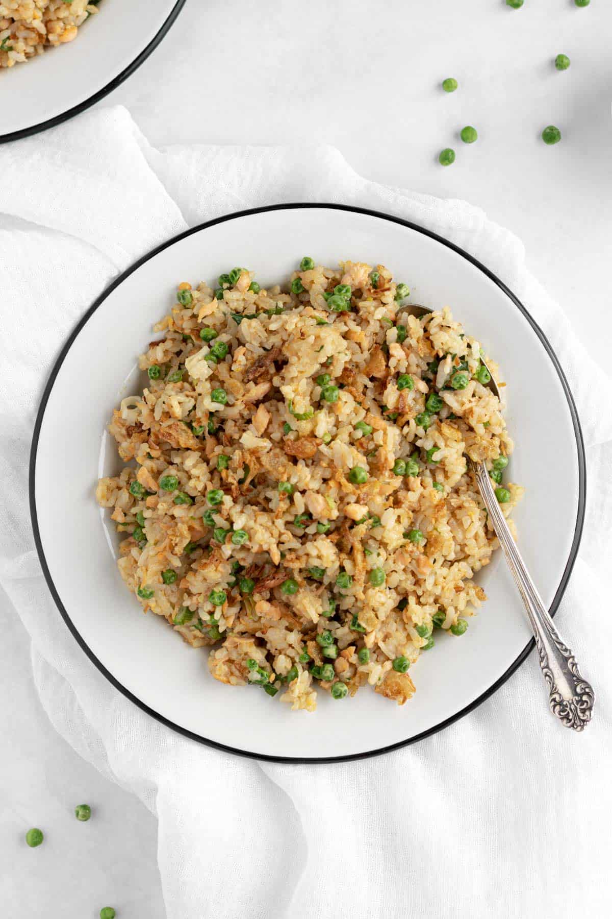 fried rice with salmon, peas, eggs, green onions and fried onions.