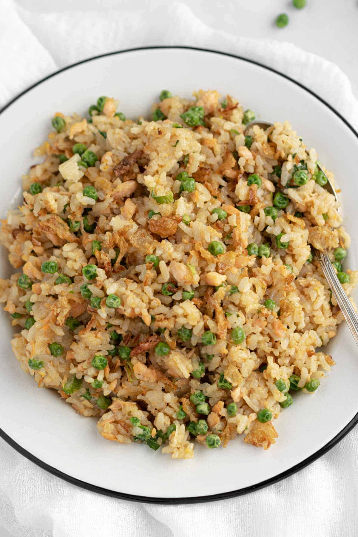 fried rice with salmon, peas, eggs, green onions and fried onions
