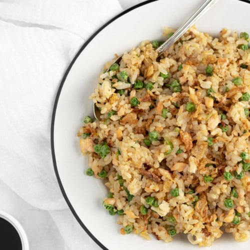 fried rice with salmon, peas, eggs, green onions and fried onions.