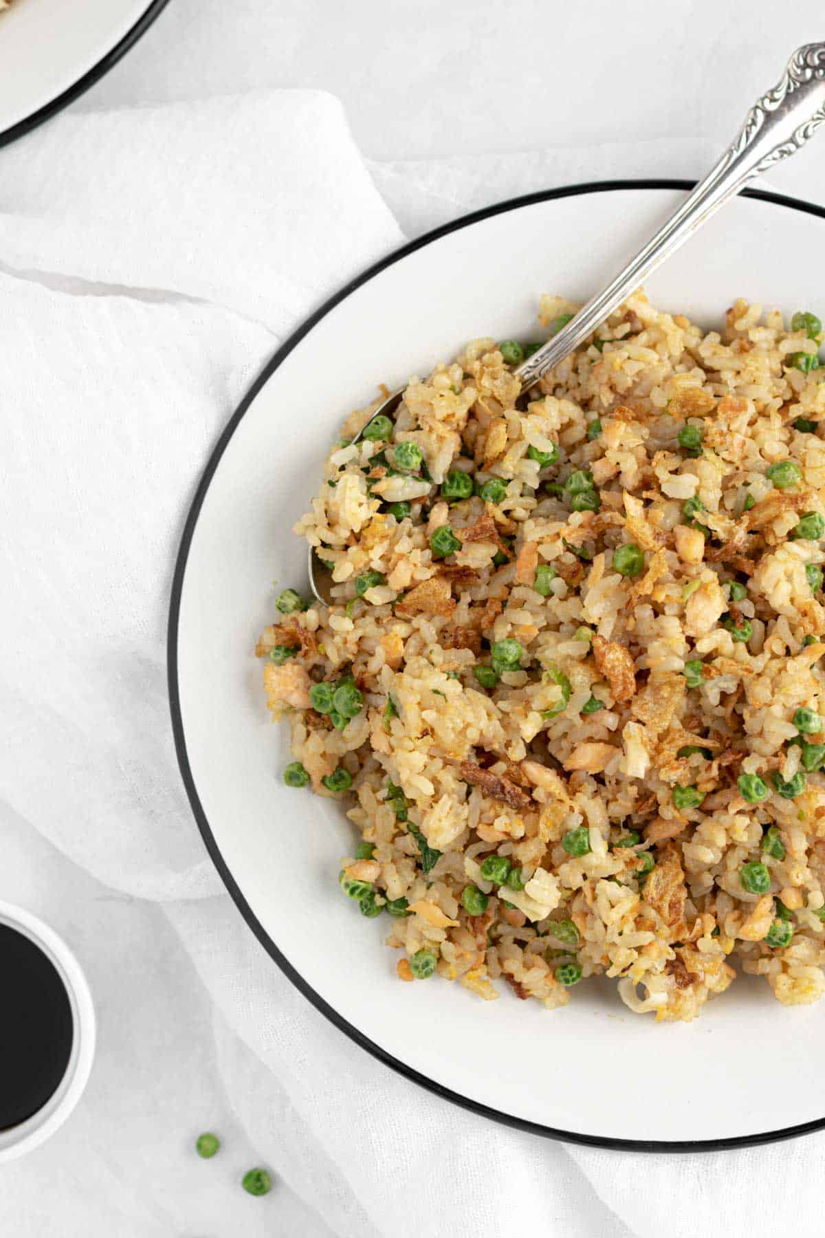 fried rice with salmon, peas, eggs, green onions and fried onions