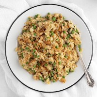 fried rice with salmon, peas, eggs, green onions and fried onions