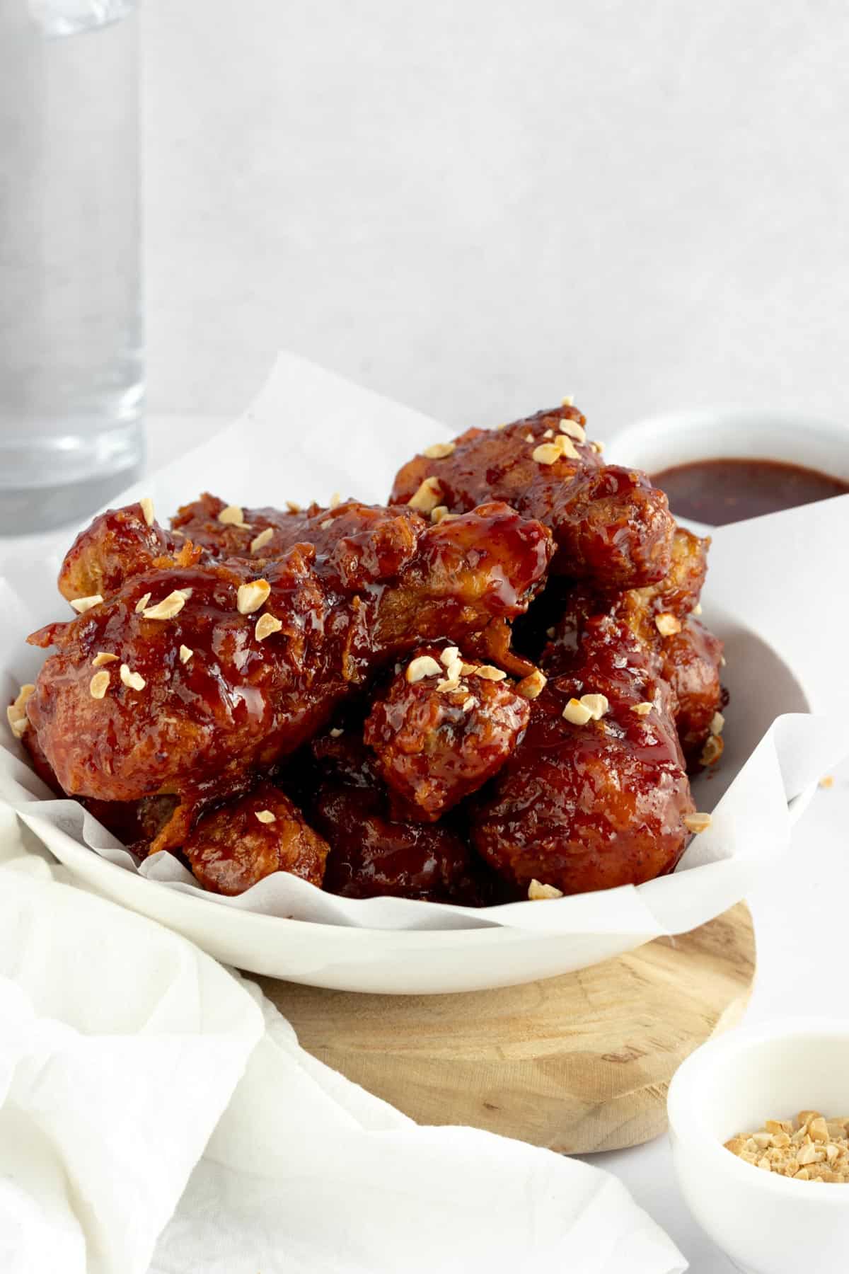 spicy korean fried chicken dakgangjeong chicken drumsticks covered with a sweet and spicy sauce sprinkled with peanuts