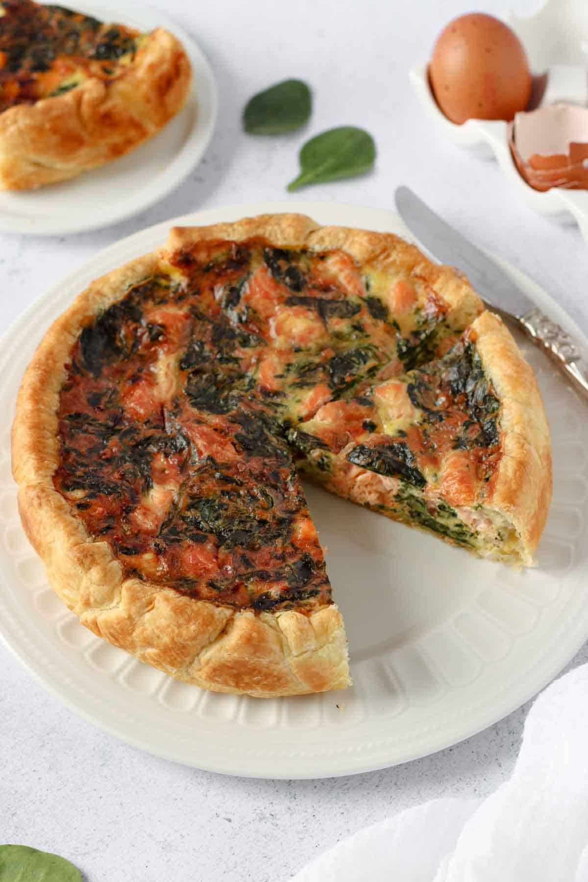 salmon and spinach quiche on a plate