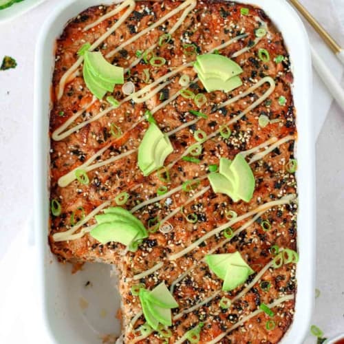 salmon sushi bake on a table with cucumber.