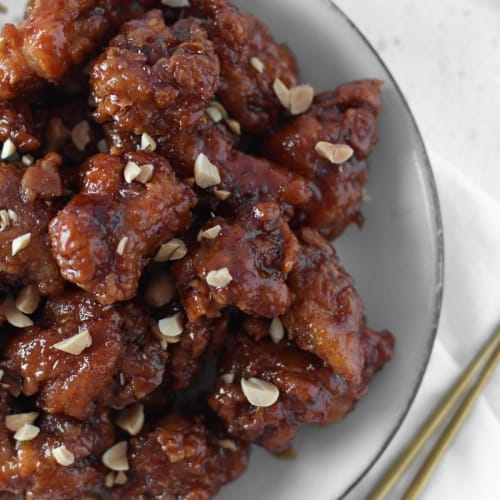 soy garlic korean fried chicken bites on a white plate.