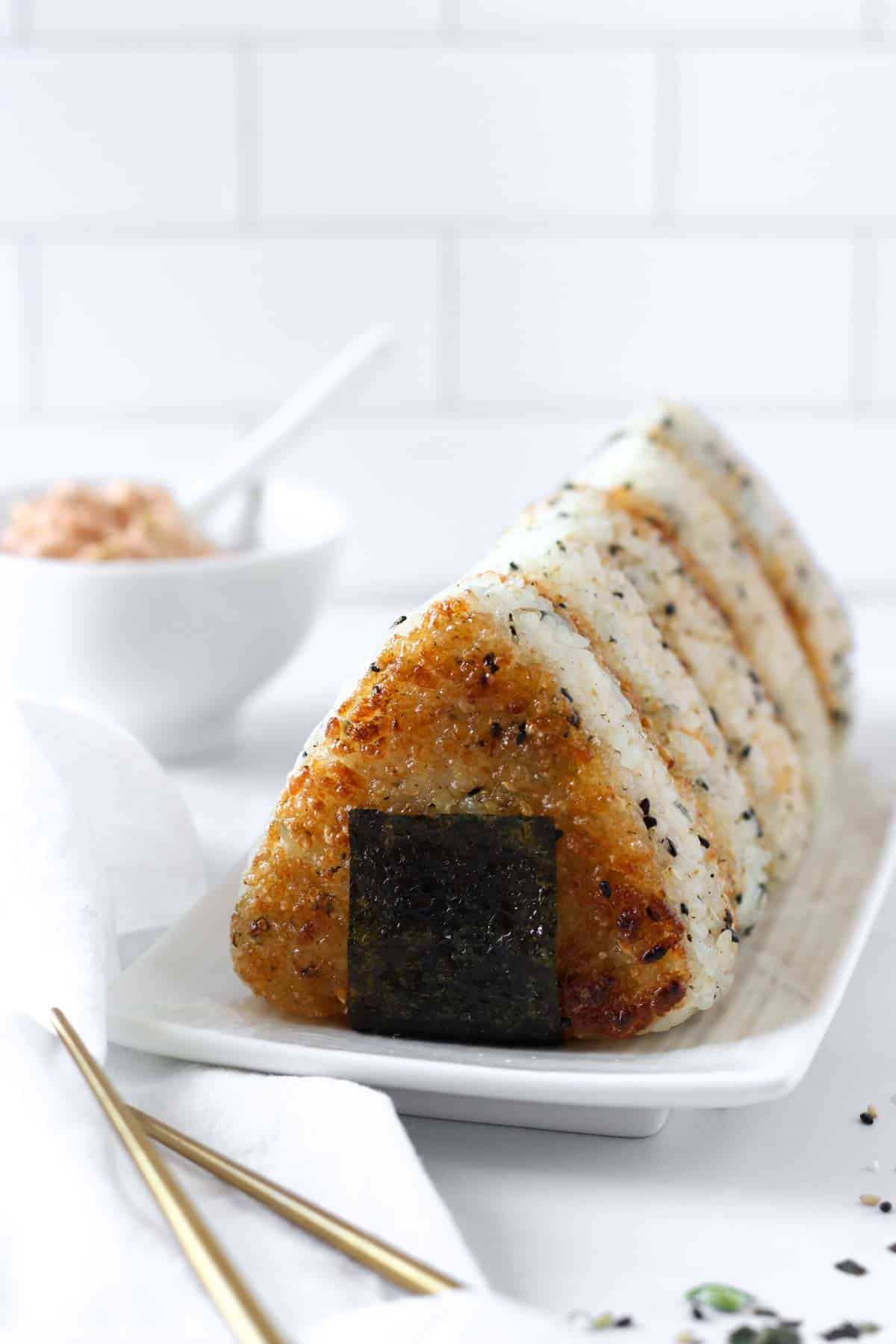 5 tuna kimchi yaki onigiri aligned on a white plate