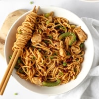 a bowl with spicy peanut butter chilli oil noodles, chicken and capsicums