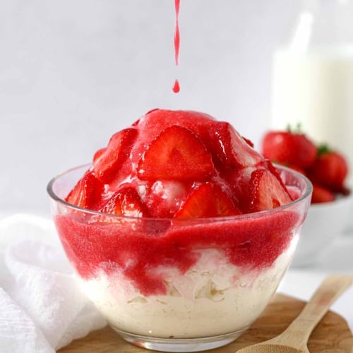 a Korean bingsu composed of milk shaved ice, cheesecake, strawberries and strawberry puree