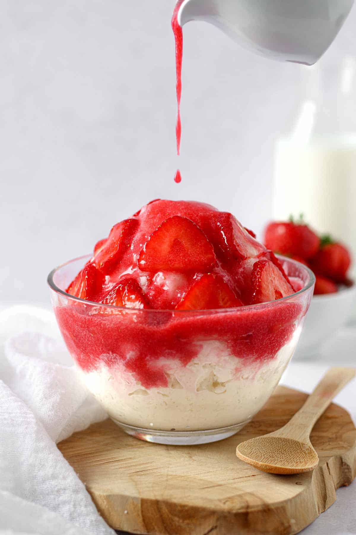 a Korean bingsu composed of milk shaved ice, cheesecake, strawberries and strawberry puree