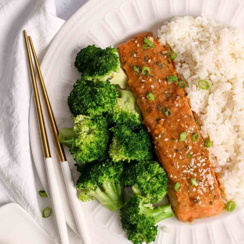 a white plate with some miso butter salmon, rice and broccoli.