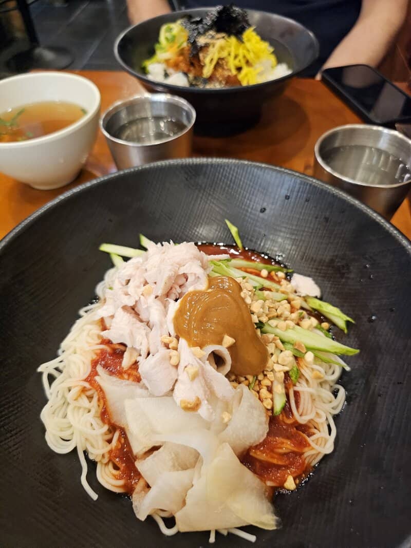 photo of a bibim guksu with mustard and pickled radish in a Hongdae restaurant.
