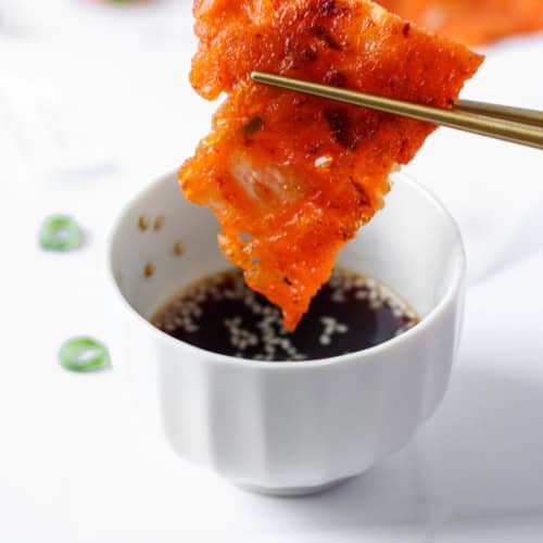 kimchi pancake dipped in sauce.