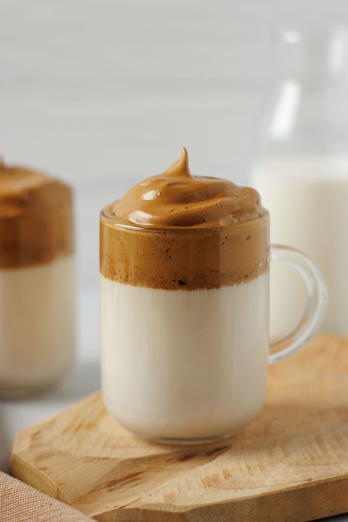 dalgona coffee with milk and coffee foam on top.