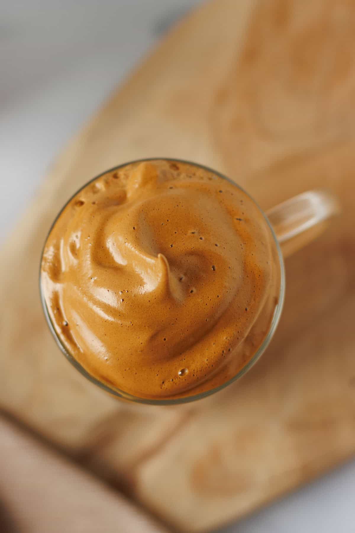 dalgona coffee shown from the top so you see the coffee foam.