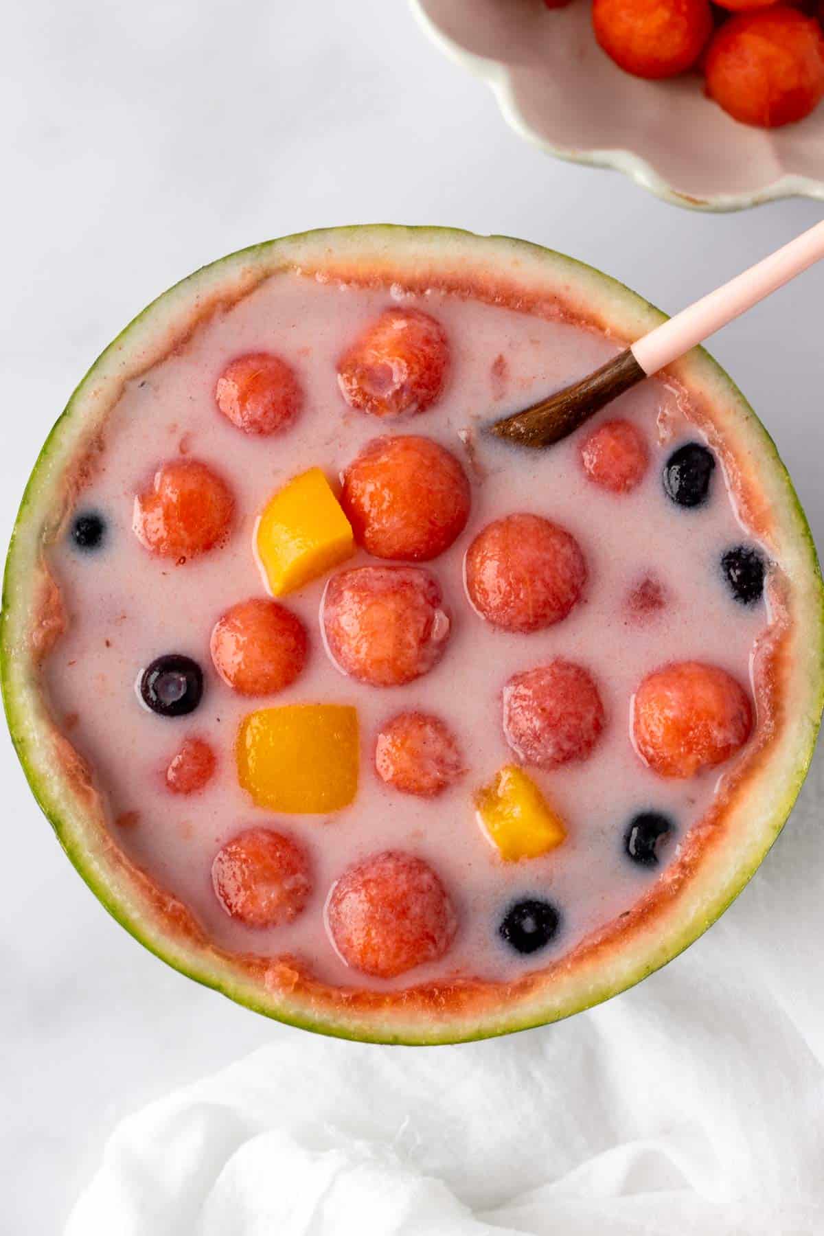 Hwachae Korean watermelon punch served in a hollowed watermelon shell.